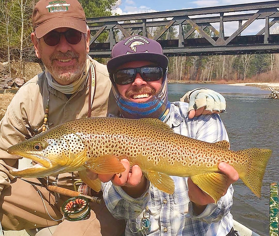 Zoo Town Anglers branded hats and fly fishing gear laid out before a guided trip