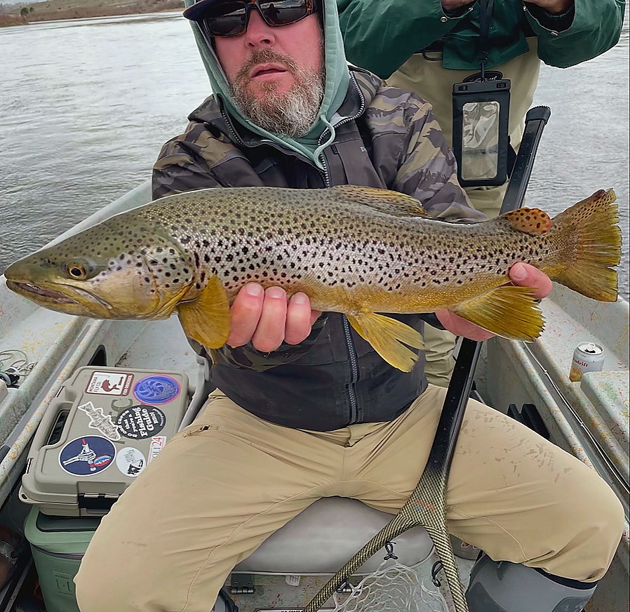 Jason holding a trophy brown trout caught on the Blackfoot River Montana